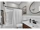 Well-lit bathroom with combined shower and tub, single sink vanity and updated fixtures at 10426 Mount Washington Ave, Las Vegas, NV 89166