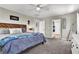 Cozy main bedroom with soft carpet, a statement headboard, and an ensuite bathroom for added privacy at 10426 Mount Washington Ave, Las Vegas, NV 89166