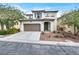 Charming two-story home features a spacious front yard, a driveway, desert landscaping, and a two-car garage at 10426 Mount Washington Ave, Las Vegas, NV 89166