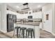 Modern kitchen boasts stainless steel appliances, granite counters, island with seating, and white cabinets at 10426 Mount Washington Ave, Las Vegas, NV 89166