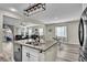 Open concept kitchen with island, breakfast nook, stainless steel appliances, and view to living room and backyard at 10426 Mount Washington Ave, Las Vegas, NV 89166