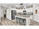 Modern kitchen featuring stainless steel appliances, granite countertops, and a stylish island with bar seating at 10426 Mount Washington Ave, Las Vegas, NV 89166