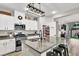 Stylish kitchen with granite countertops, stainless steel appliances, pantry, and an open view into the living area at 10426 Mount Washington Ave, Las Vegas, NV 89166