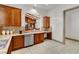 Kitchenette with stainless steel appliances, brown cabinetry, and breakfast bar at 10426 Mount Washington Ave, Las Vegas, NV 89166