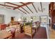 Comfortable community living room with ceiling fans, beams, and couches at 10426 Mount Washington Ave, Las Vegas, NV 89166