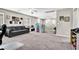 Spacious living room featuring neutral paint, a comfortable sofa, and a playhouse at 10426 Mount Washington Ave, Las Vegas, NV 89166