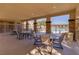 Outdoor patio area with tables and chairs next to the pool at 10426 Mount Washington Ave, Las Vegas, NV 89166