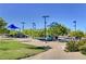 Community playground with slides, climbing structures, and shade canopies, set in a well-maintained park with trees and landscaping at 10426 Mount Washington Ave, Las Vegas, NV 89166