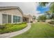 Landscaped backyard featuring green grass, and lush plants at 1100 Cypress Ridge Ln, Las Vegas, NV 89144