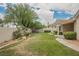 View of backyard, with green grass, and some trees at 1100 Cypress Ridge Ln, Las Vegas, NV 89144