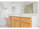 Spacious bathroom featuring a large mirror, a vanity with wooden cabinets, and a shower behind a glass door at 1100 Cypress Ridge Ln, Las Vegas, NV 89144