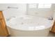 A close up of a luxurious, white jacuzzi bathtub with jets and window shutters in the bathroom at 1100 Cypress Ridge Ln, Las Vegas, NV 89144