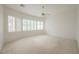 Bright bedroom with large window and ceiling fan at 1100 Cypress Ridge Ln, Las Vegas, NV 89144