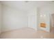 Bright bedroom featuring light wood floors, white walls, and a closet with sliding doors, plus an ensuite bathroom at 1100 Cypress Ridge Ln, Las Vegas, NV 89144