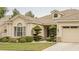 A close-up view of a charming single-story home with well-manicured landscaping and a two-car garage at 1100 Cypress Ridge Ln, Las Vegas, NV 89144