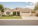 Charming single-story home with a well-manicured lawn, mature trees, and a two-car garage at 1100 Cypress Ridge Ln, Las Vegas, NV 89144