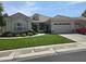 Charming single-story home featuring a well-manicured lawn, mature landscaping, and a three-car garage at 1100 Cypress Ridge Ln, Las Vegas, NV 89144