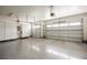 Spacious garage with epoxy floors, storage cabinets, and two car garage doors at 1100 Cypress Ridge Ln, Las Vegas, NV 89144