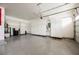 Spacious garage with epoxy floors, storage cabinets, and two car garage doors at 1100 Cypress Ridge Ln, Las Vegas, NV 89144