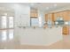Well-lit kitchen featuring an island, an exterior door and light wood cabinets at 1100 Cypress Ridge Ln, Las Vegas, NV 89144