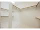 Spacious walk-in closet with white walls, white tiled floors, and wooden shelves at 1100 Cypress Ridge Ln, Las Vegas, NV 89144