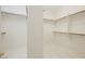 Large walk-in closet with white walls, white tiled floors, and wooden shelves at 1100 Cypress Ridge Ln, Las Vegas, NV 89144