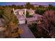 Stunning aerial view of estate home with tile roof, lush landscaping and circular driveway at 12056 Royal Dolnoch Ct, Las Vegas, NV 89141