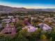 Scenic aerial view of the luxury community, showcasing the lush landscape at sunset at 12056 Royal Dolnoch Ct, Las Vegas, NV 89141
