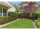 Lush backyard featuring a well-maintained lawn and manicured hedges, perfect for outdoor enjoyment at 12056 Royal Dolnoch Ct, Las Vegas, NV 89141