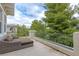 Inviting balcony features comfortable lounge seating with views of mature trees and blue sky at 12056 Royal Dolnoch Ct, Las Vegas, NV 89141
