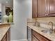 Granite countertop, wine fridge, and cabinets make this bar area perfect for entertaining at 12056 Royal Dolnoch Ct, Las Vegas, NV 89141
