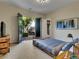 Bright bedroom with exposed frame bed and french doors leading to a private yard at 12056 Royal Dolnoch Ct, Las Vegas, NV 89141