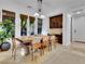 Bright dining room with large windows, wooden dining table, and built-in cabinets at 12056 Royal Dolnoch Ct, Las Vegas, NV 89141