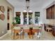 Sunlit dining room with French doors, chandelier, and custom cabinets at 12056 Royal Dolnoch Ct, Las Vegas, NV 89141