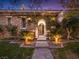 Elegant stone home with beautifully landscaped front entrance and a welcoming gate at 12056 Royal Dolnoch Ct, Las Vegas, NV 89141