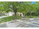 Charming home featuring a stone facade, mature trees, and a beautifully landscaped front yard at 12056 Royal Dolnoch Ct, Las Vegas, NV 89141