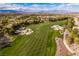 Aerial view of a meticulously manicured golf course with sand traps in a luxury community at 12056 Royal Dolnoch Ct, Las Vegas, NV 89141