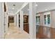 Spacious hallway with tile flooring, leading to a grand living area with natural light and wood floors at 12056 Royal Dolnoch Ct, Las Vegas, NV 89141