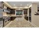 Gourmet kitchen features a large island, stainless steel appliances, and dark wood cabinetry at 12056 Royal Dolnoch Ct, Las Vegas, NV 89141