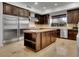 Gourmet kitchen with granite countertops, stainless steel appliances, and a large center island with ample storage at 12056 Royal Dolnoch Ct, Las Vegas, NV 89141
