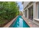 Modern lap pool beside home featuring clean lines and a serene view at 12056 Royal Dolnoch Ct, Las Vegas, NV 89141