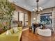 Elegant living room featuring a piano, modern chandelier and sophisticated decor at 12056 Royal Dolnoch Ct, Las Vegas, NV 89141