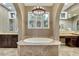 Relaxing main bathroom features a soaking tub, dual sinks, and elegant lighting at 12056 Royal Dolnoch Ct, Las Vegas, NV 89141