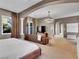 Lavish main bedroom features an elegant sitting area and access to a private balcony at 12056 Royal Dolnoch Ct, Las Vegas, NV 89141