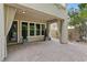 Spacious outdoor patio with covered area offering room to entertain, featuring brick pavers at 12056 Royal Dolnoch Ct, Las Vegas, NV 89141