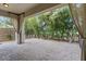 Covered patio featuring decorative curtains and lush privacy landscaping with pavers at 12056 Royal Dolnoch Ct, Las Vegas, NV 89141
