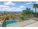 Balcony with a scenic view of the desert, pool, and mountains in the distance under a sunny sky with fluffy clouds at 1221 Diamond Valley St, Henderson, NV 89052