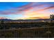 A captivating balcony view featuring the city skyline at dusk, framed by wrought iron railings at 1221 Diamond Valley St, Henderson, NV 89052