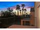 A balcony view showcasing the city lights and palm trees, framed by wrought iron railings at 1221 Diamond Valley St, Henderson, NV 89052