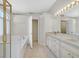 Bright bathroom featuring double sinks, marble countertops, separate shower and tub at 1221 Diamond Valley St, Henderson, NV 89052